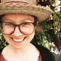 Emily in a hat, under a tree